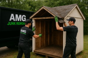 AMG Junk Removal team clearing out garage clutter with their branded truck
