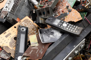 Assorted old electronics stacked for removal from a residential property