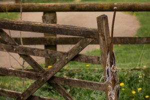 A broken and leaning wooden fence detracts from the exterior appeal of a home