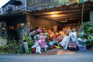 A cluttered garage overflowing with boxes, bags, and miscellaneous items