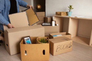 A man placing items into a donation box as part of spring decluttering